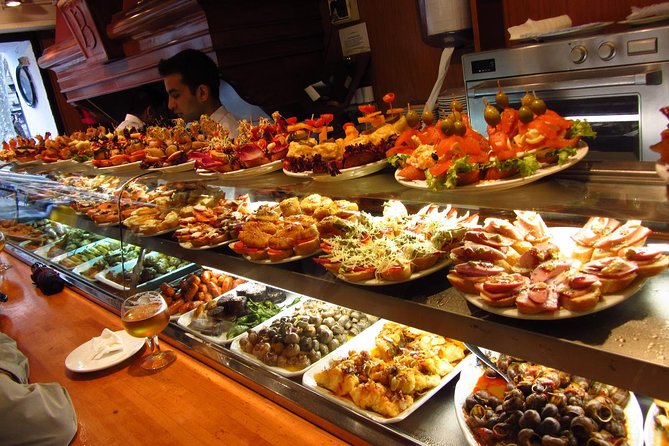 Night Tapas Walking Tour in Barcelona Modernist Area with Small Group and Dinner - Third stop: a local tapas bar with fish, meat, and vegetables